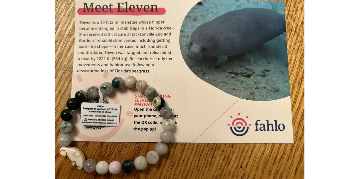 A Fahlo QR Code bracelet with a promotional material on the user manual.