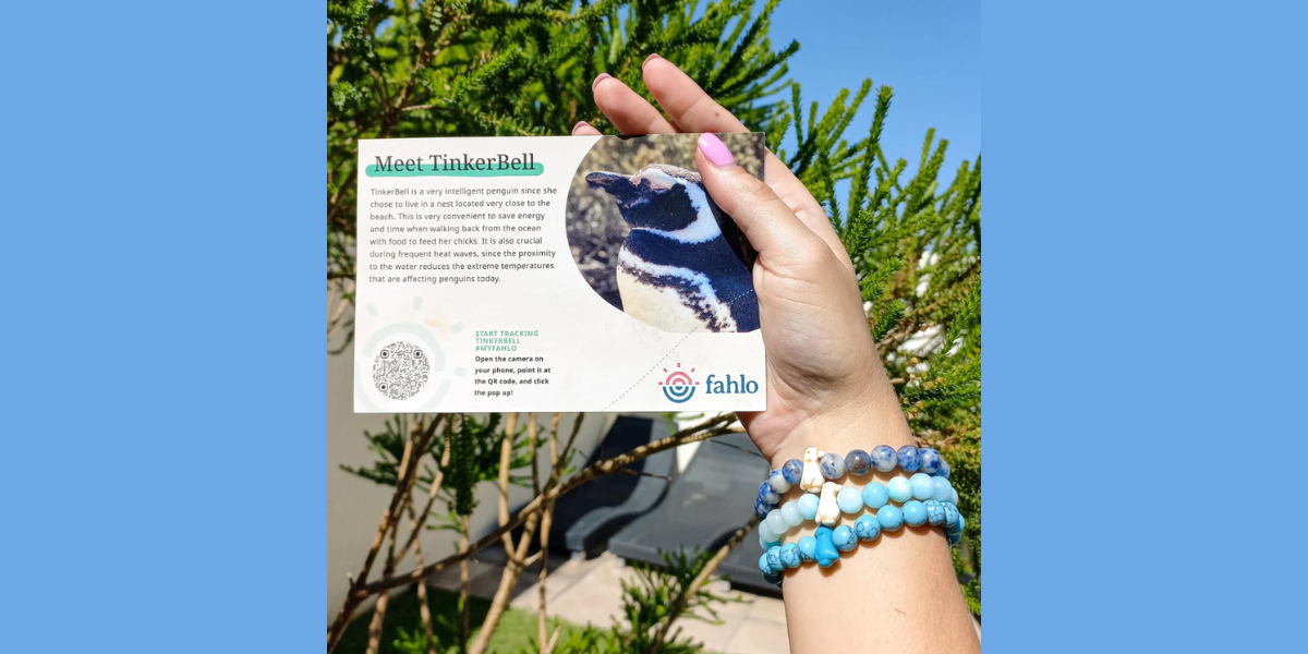 A human hand with a Fahlo QR Code card.