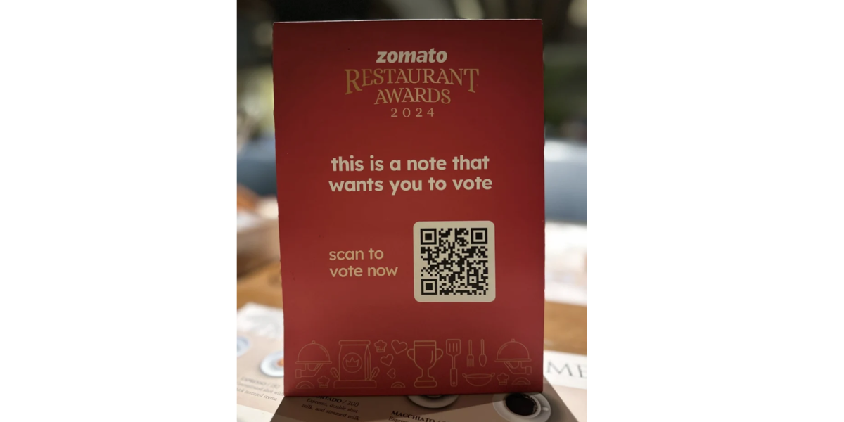 A Burger King QR Code sticker on a table.