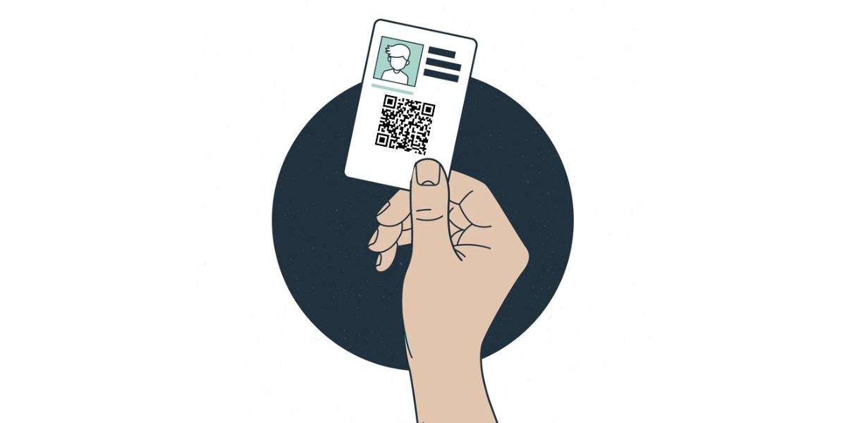A hand holding a badge with QR Code.