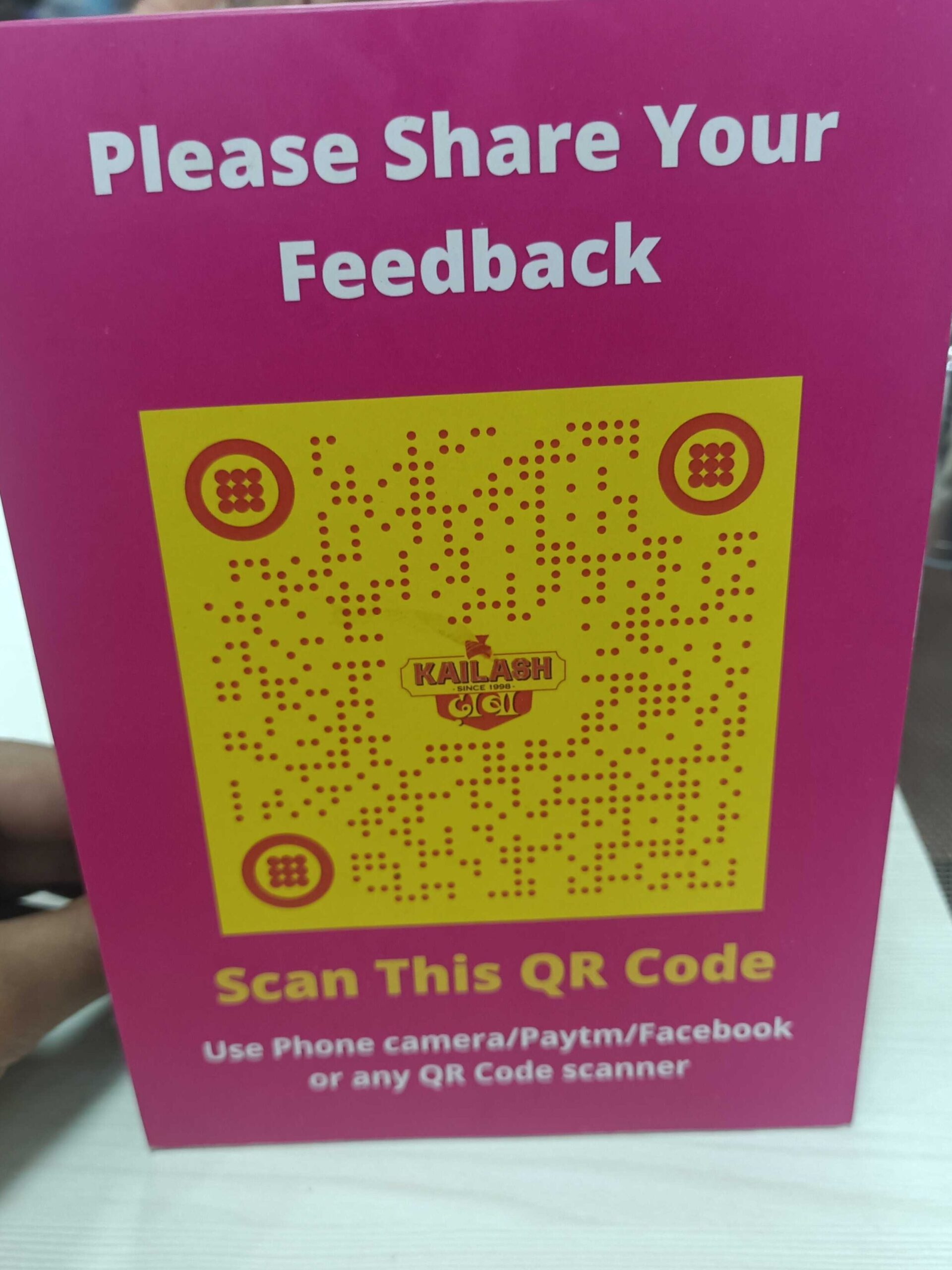 A QR Code for feedback on a table top.