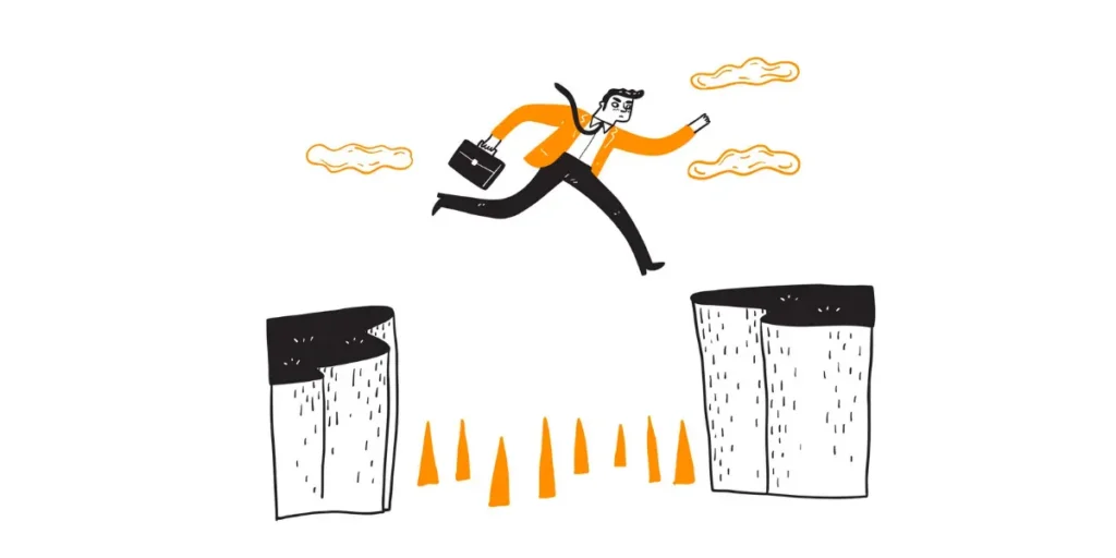  A man jumping over a gap in a cliff, the gap has thorns.