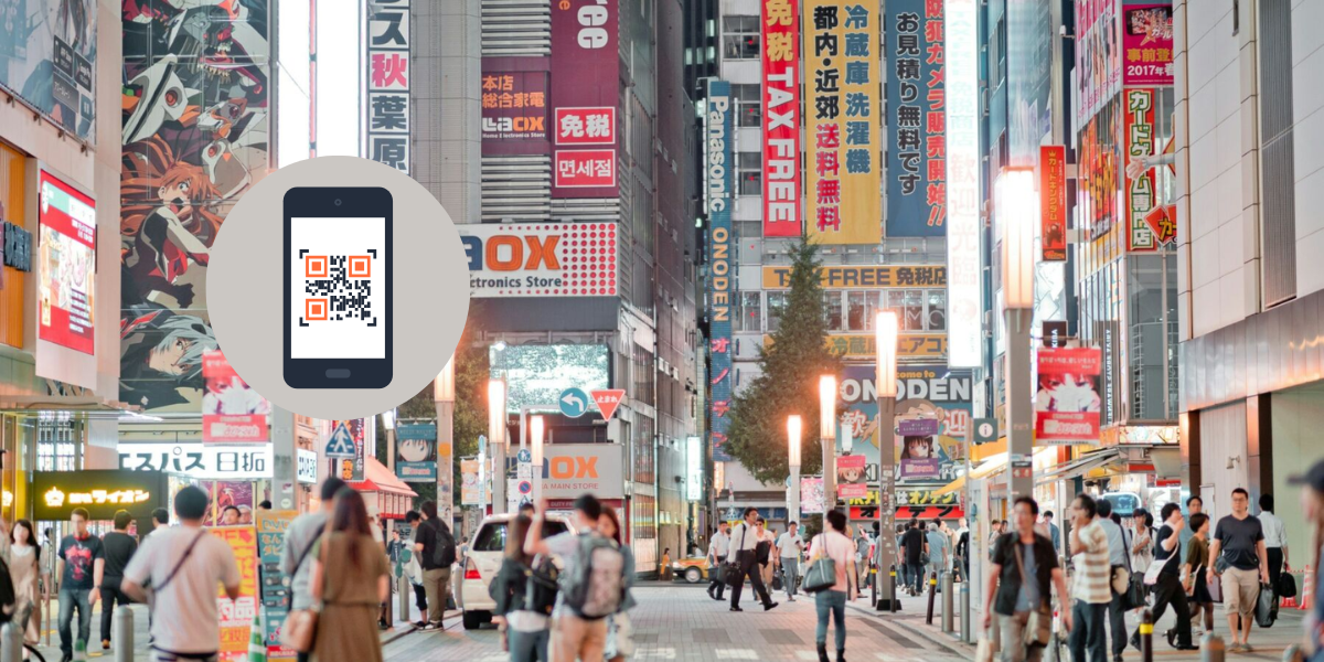 A busy street showing QR Codes in Japan