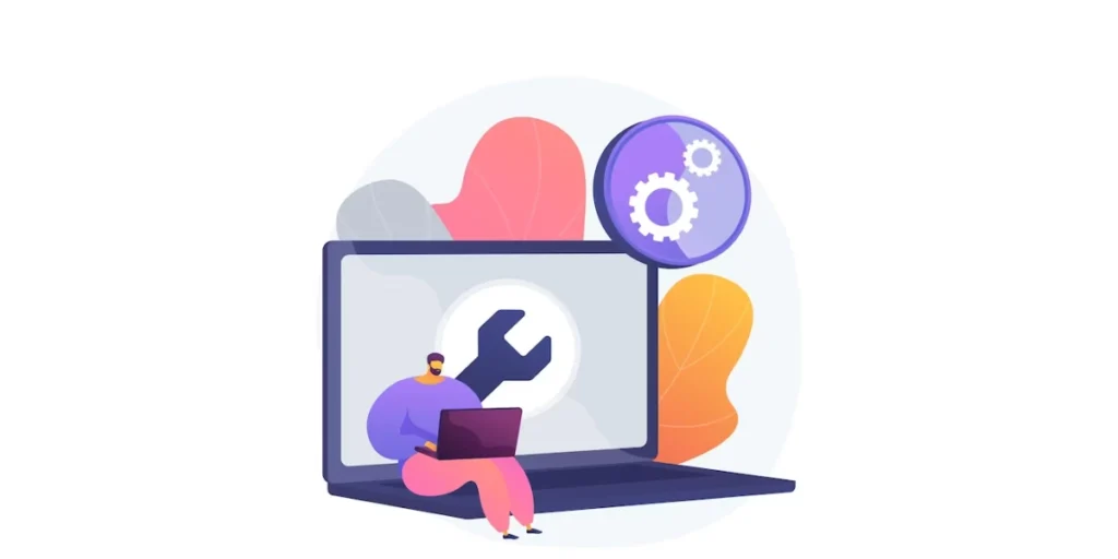 a person working on a laptop and another fixing a giant gear with a wrench